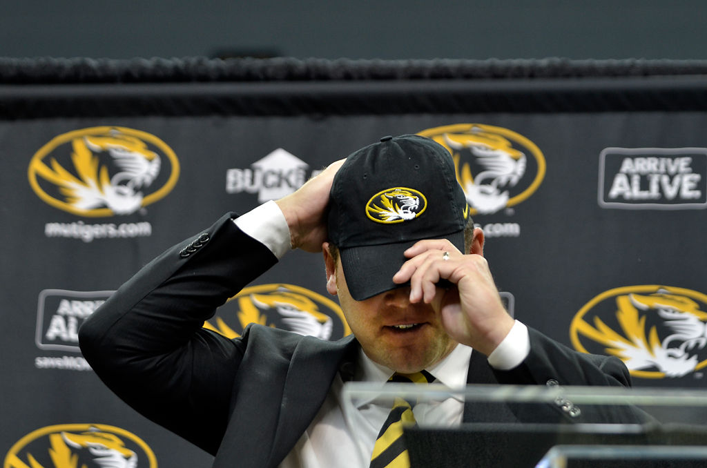Barry Odom adjusts his hat